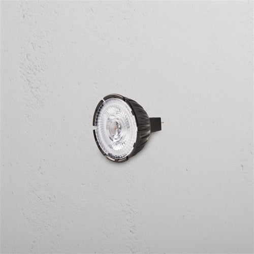 Leopold 7W 50mm 24V LED MR16 24° GU10 bulb with clear lens and black base, shown mounted on a wall.